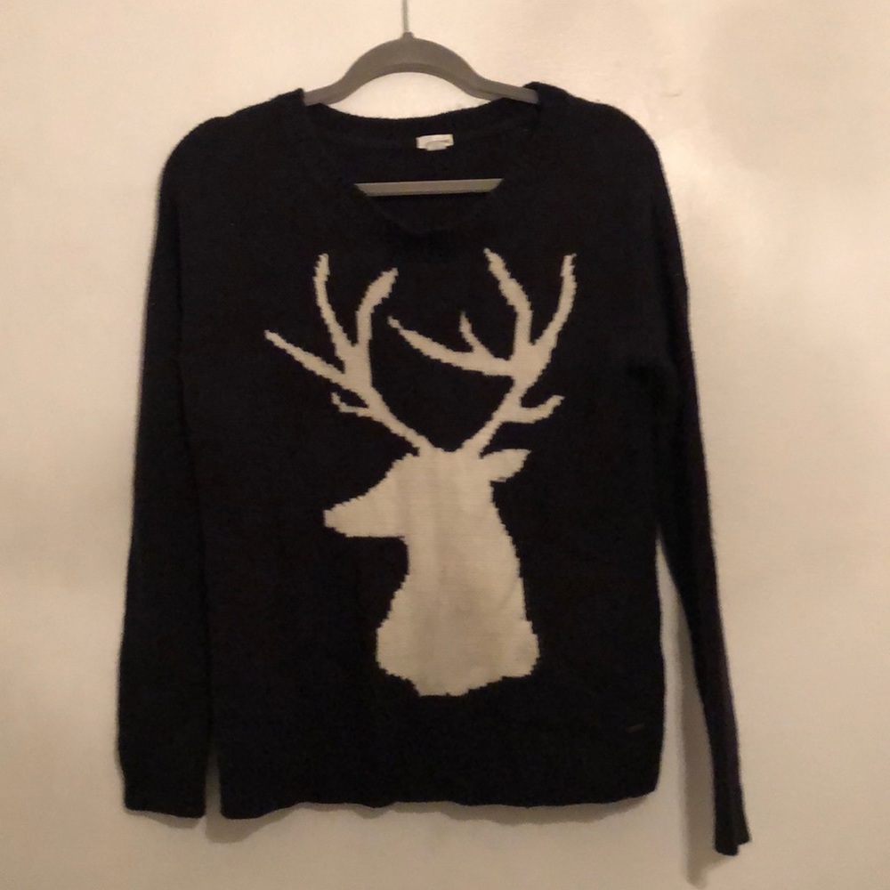 Black knit sweater with white deer with antlers.